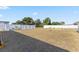Expansive backyard featuring a white fence and ample green space, ideal for outdoor activities at 3341 Lounging Wren Ln, Bartow, FL 33830