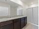Bright bathroom boasting a double granite vanity, spacious mirror, and a shower with a white curtain at 3341 Lounging Wren Ln, Bartow, FL 33830