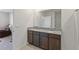 Elegant bathroom features a double granite vanity, large mirror, and a shower with clear glass doors at 3341 Lounging Wren Ln, Bartow, FL 33830