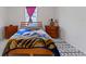 Cozy bedroom featuring a charming patterned rug, a comfortable bed, and matching wooden nightstands at 3341 Lounging Wren Ln, Bartow, FL 33830
