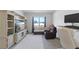 Bright bedroom featuring a large window, with an accent wall at 3341 Lounging Wren Ln, Bartow, FL 33830