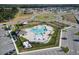 Aerial view of community pool and playground, with parking, showcasing resident amenities at 3341 Lounging Wren Ln, Bartow, FL 33830