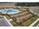 Aerial view of the dog park, with a gated entrance, in a community setting, next to the pool at 3341 Lounging Wren Ln, Bartow, FL 33830