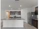 Open kitchen featuring granite countertops, stainless steel appliances, tile floors, and a kitchen island at 3341 Lounging Wren Ln, Bartow, FL 33830