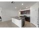 Well-lit kitchen featuring stainless steel appliances, an island, and sleek, granite countertops at 3341 Lounging Wren Ln, Bartow, FL 33830