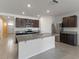 Bright kitchen featuring an island with granite countertops, stainless steel appliances, and tile flooring at 3341 Lounging Wren Ln, Bartow, FL 33830