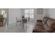 Bright living room featuring a dining table, a large window, and comfortable sofa at 3341 Lounging Wren Ln, Bartow, FL 33830