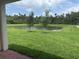 Lush green backyard featuring a pond and mature trees at 3450 Mclain Preserve Pt, Sanford, FL 32771