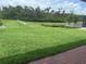 A well-manicured lawn with a scenic pond in the backyard at 3450 Mclain Preserve Pt, Sanford, FL 32771