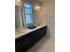 Bathroom with dark cabinets, double vanity and large mirrors at 3450 Mclain Preserve Pt, Sanford, FL 32771