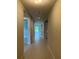 Long, well-lit hallway featuring tile flooring at 3450 Mclain Preserve Pt, Sanford, FL 32771