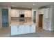 Bright and spacious kitchen features white cabinetry, a central island, and stainless steel appliances at 3450 Mclain Preserve Pt, Sanford, FL 32771