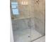 Bathroom shower with glass door and beautiful marble tiling at 3450 Mclain Preserve Pt, Sanford, FL 32771