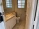 Bathroom with a window, featuring tiled floors and a vanity; natural light and fresh ambiance at 4001 San Sabastian Dr # 107, Kissimmee, FL 34741