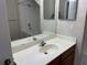Bathroom featuring a single sink vanity, tub and shower with tile surround at 4001 San Sabastian Dr # 107, Kissimmee, FL 34741