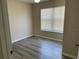 Bedroom featuring wood-look floors, ceiling fan, and a window with white blinds at 4001 San Sabastian Dr # 107, Kissimmee, FL 34741
