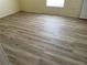 Bedroom featuring modern flooring and white trim complemented by neutral walls and a closet at 4001 San Sabastian Dr # 107, Kissimmee, FL 34741
