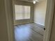 Bedroom features wood-look floors, ceiling fan, and a window with white blinds at 4001 San Sabastian Dr # 107, Kissimmee, FL 34741