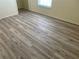 Bright bedroom featuring laminate floors and a window with blinds at 4001 San Sabastian Dr # 107, Kissimmee, FL 34741
