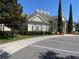 Exterior of the clubhouse with manicured landscaping, stately columns, and ample parking at 4001 San Sabastian Dr # 107, Kissimmee, FL 34741