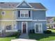 Inviting townhouse featuring colorful facade, well-maintained landscaping, and a cozy, welcoming entrance at 4001 San Sabastian Dr # 107, Kissimmee, FL 34741
