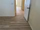 Hallway featuring laminate floors and neutral colored walls at 4001 San Sabastian Dr # 107, Kissimmee, FL 34741