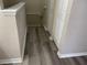 Upstairs hallway featuring modern gray wood-look flooring, white trim and neutral wall colors, plus a closet at 4001 San Sabastian Dr # 107, Kissimmee, FL 34741