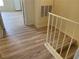 Upstairs landing featuring modern flooring, a landing railing and neutral wall colors, plus an AC vent at 4001 San Sabastian Dr # 107, Kissimmee, FL 34741