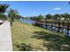 Beautiful pond view with wooden dock, fountain, and lush green landscape, perfect for a serene escape at 4001 San Sabastian Dr # 107, Kissimmee, FL 34741