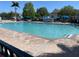 Community pool with lounge chairs and umbrellas at 4001 San Sabastian Dr # 107, Kissimmee, FL 34741