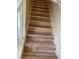 Light wood-look steps featuring white risers and stringers lead to the upper level at 4001 San Sabastian Dr # 107, Kissimmee, FL 34741