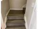 View of the stairwell featuring wood-look steps and white trim at 4001 San Sabastian Dr # 107, Kissimmee, FL 34741