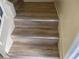 Staircase with light wood-look steps and off-white painted risers and stringers at 4001 San Sabastian Dr # 107, Kissimmee, FL 34741
