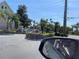 A street view features lush greenery, palm trees, and well-maintained landscaping at 4001 San Sabastian Dr # 107, Kissimmee, FL 34741