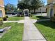 Community walkway with manicured lawn at 4001 San Sabastian Dr # 107, Kissimmee, FL 34741