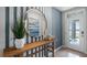 Bright entryway featuring a round mirror, striped accent wall, and decorative console table at 404 Taylor Groves Dr, Lake Wales, FL 33853