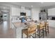 Bright kitchen features a central island with barstool seating and stainless steel appliances at 404 Taylor Groves Dr, Lake Wales, FL 33853