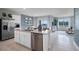 Bright kitchen with stainless steel appliances, central island and views to the living area at 404 Taylor Groves Dr, Lake Wales, FL 33853
