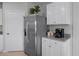 Kitchen area boasts stainless steel refrigerator, white cabinets and a Keurig coffee maker at 404 Taylor Groves Dr, Lake Wales, FL 33853