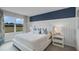 Cozy bedroom features a king bed, accent wall and a large window with natural light at 404 Taylor Groves Dr, Lake Wales, FL 33853