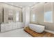Spa-like bathroom featuring a standalone tub, double vanity, and ample natural light at 4047 Isabella Cir, Windermere, FL 34786