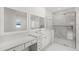 Bright bathroom with double vanity, make up table, and glass shower at 4047 Isabella Cir, Windermere, FL 34786