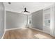 Bedroom featuring hardwood floors, modern fan and textured accent wall at 4047 Isabella Cir, Windermere, FL 34786