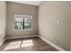 A neutral bedroom offers wood floors, recessed lighting, and a bright window at 4047 Isabella Cir, Windermere, FL 34786