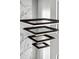 Modern geometric chandelier adds style to the luxury home's sleek design, with white marble accent at 4047 Isabella Cir, Windermere, FL 34786