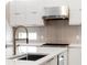 Close up of a modern kitchen island with stainless steel faucet, sink, and white countertop that enhances functionality at 4047 Isabella Cir, Windermere, FL 34786
