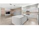Modern kitchen island that flows into living room area with mounted television and space for entertaining at 4047 Isabella Cir, Windermere, FL 34786