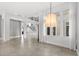 Bright living room features a contemporary chandelier, neutral walls and large windows, and lots of natural light at 4047 Isabella Cir, Windermere, FL 34786