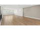 Bright, spacious living room with light hardwood floors and ample natural light from three windows at 4047 Isabella Cir, Windermere, FL 34786