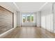 Bright, open living room boasts wood floors and large windows with abundant natural light at 4047 Isabella Cir, Windermere, FL 34786